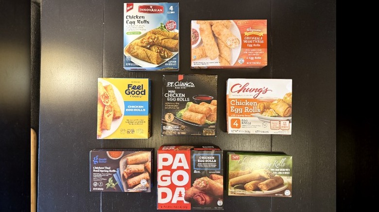 Boxes of frozen chicken egg rolls, including Innovasian, Wegmans, Feel Good, Good & Gather, P.F. Changs, Pagoda, Chung's, and Trader Joe's