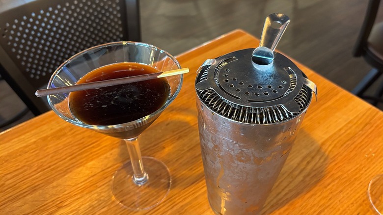 Applebee's Espres-So Happy Martini next to shaker on wooden table