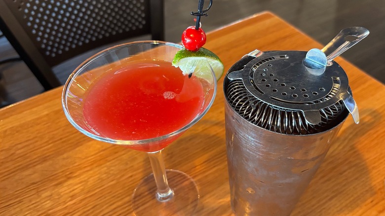 Applebee's Perfect Cranberry Margarita next to shaker on wooden table