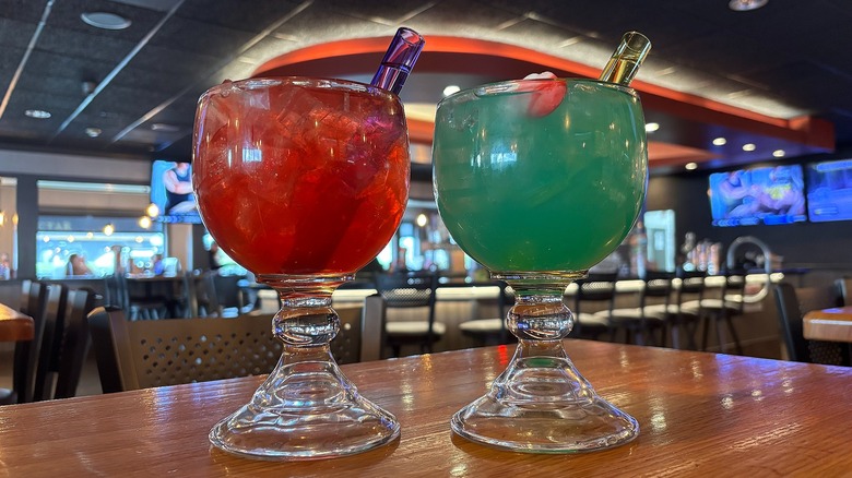 Two Applebee's holiday cocktails with vibe shots on wooden table