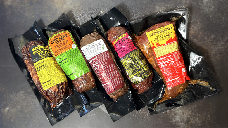 five packages of trader joes marinated beef products