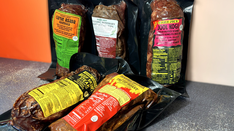 five packages of trader joes marinated beef products