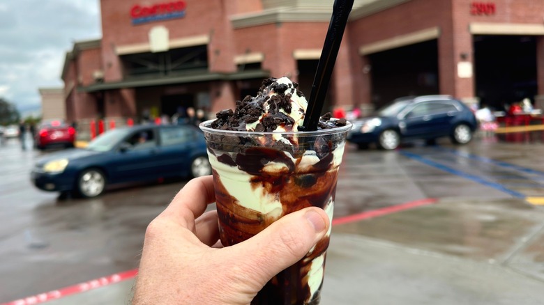 a hand holding the double chocolate mint sundae in front of costco