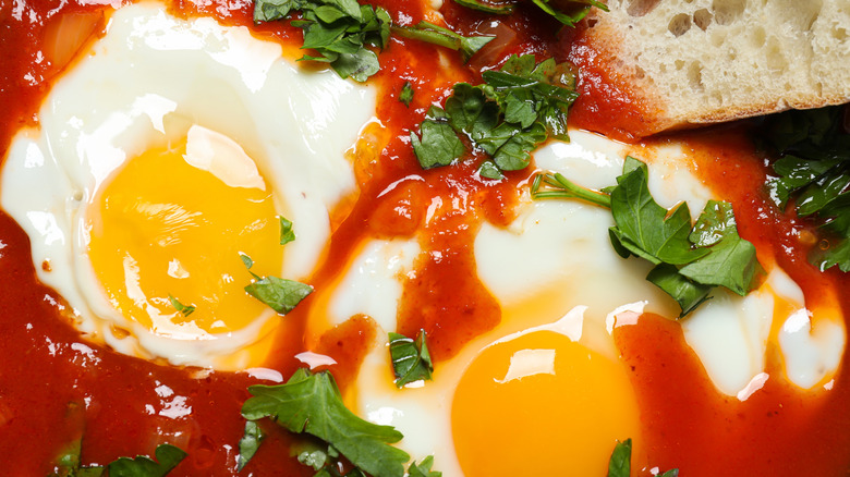 Close up of eggs cooked in tomatoes