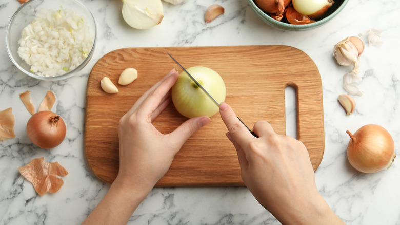 Chopping onion on cutting board
