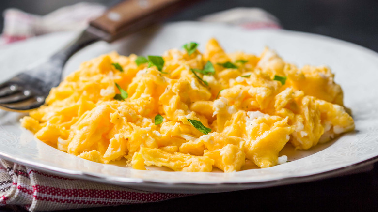 Scrambled eggs and herbs plate