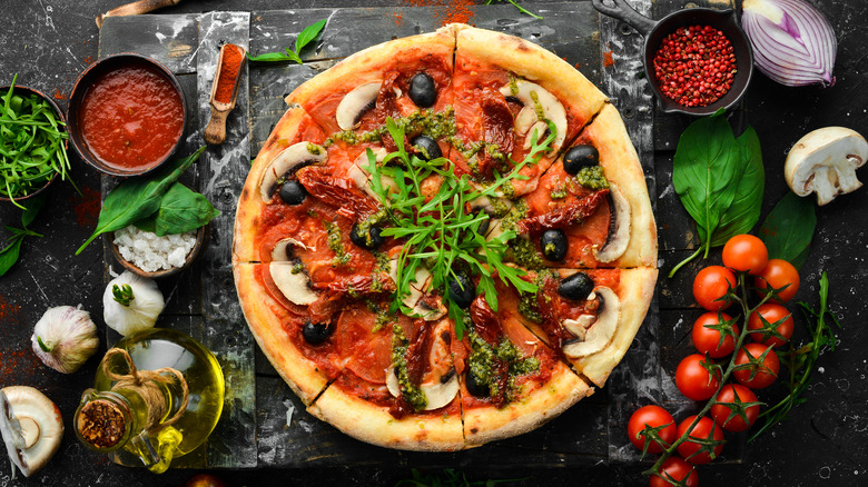 Veggie pizza on black countertop 