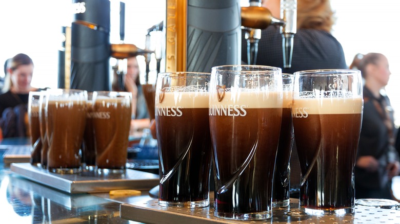 Pints of Guinness settling on bar