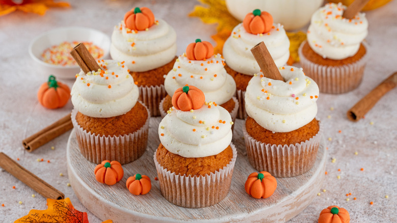 Plate of pumpkin cupcakes with frosting