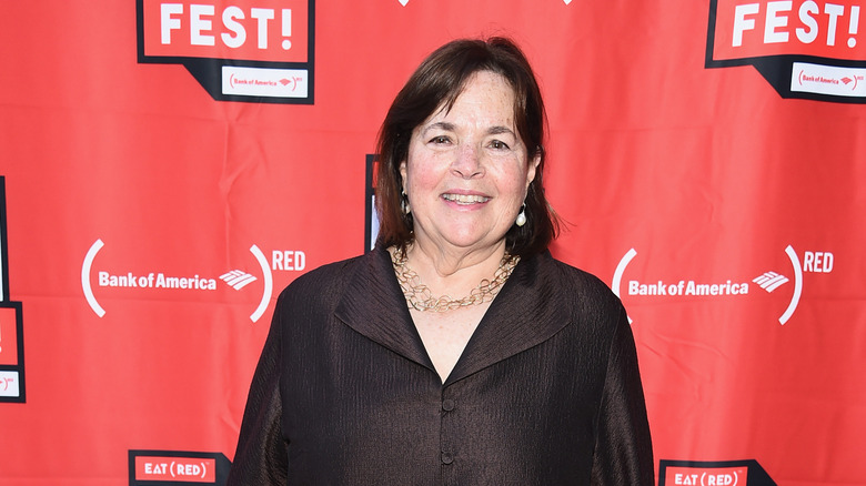 Ina Garten at an event with red background