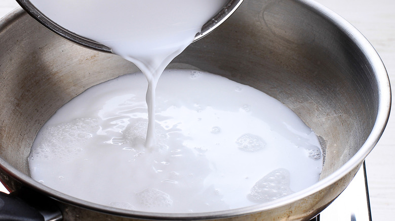 coconut milk pouring into pan
