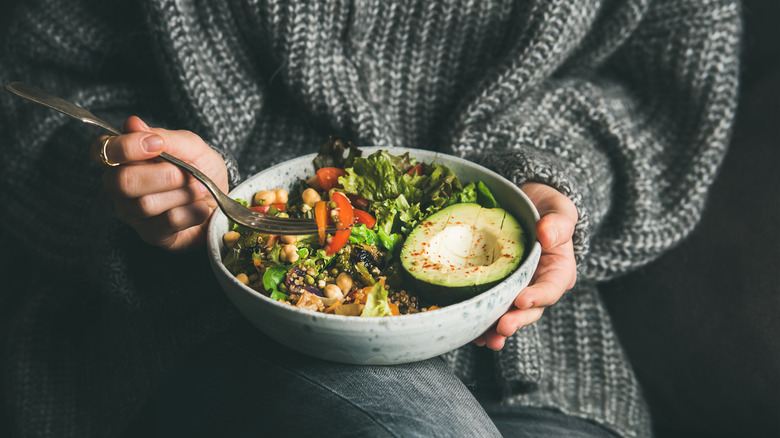 Woman eating Buddha bowl