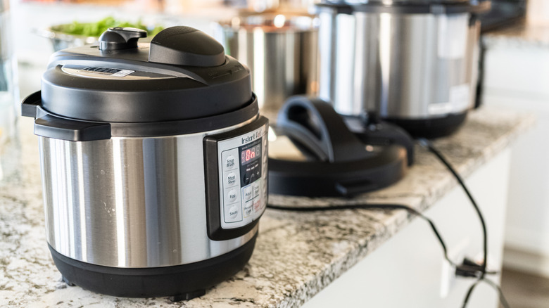 Instant Pot on a kitchen counter with other pressure cookers