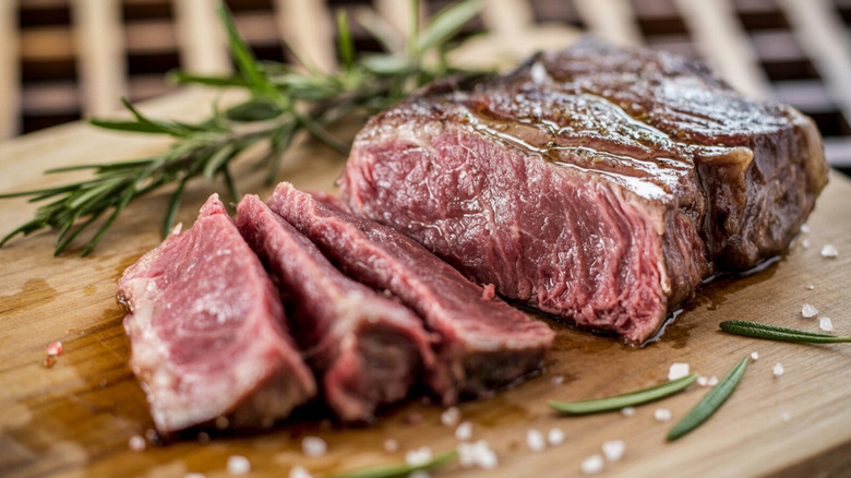 Medium-rare New York strip steak with rosemary and sea salt.