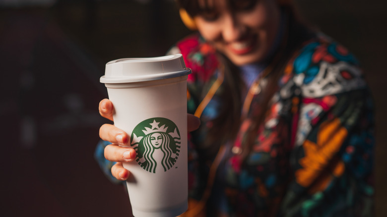Woman holding Starbucks drink