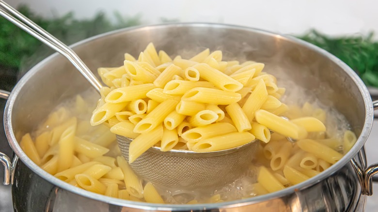 Pasta being lifted from boiling water