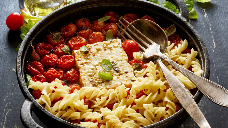A pasta dish with cherry tomatoes and feta cheese