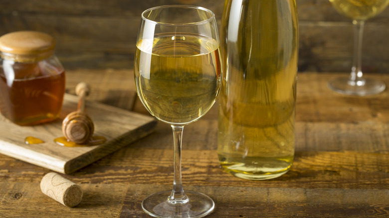 Mead in wine glass with honey