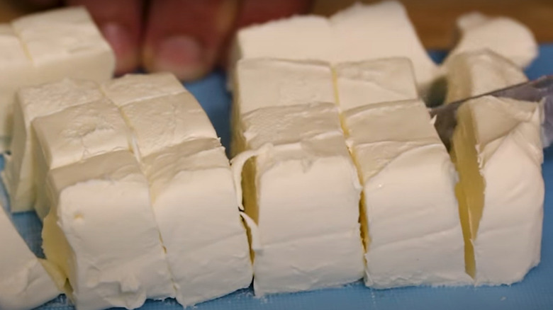 Cutting cream cheese into cubes