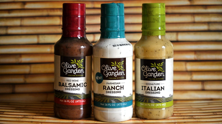 three unopened bottles of olive garden dressing