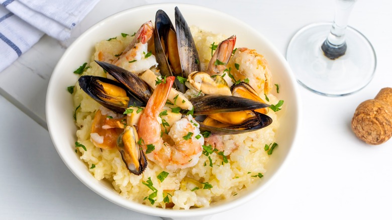 Shrimp and mussel risotto on white plate