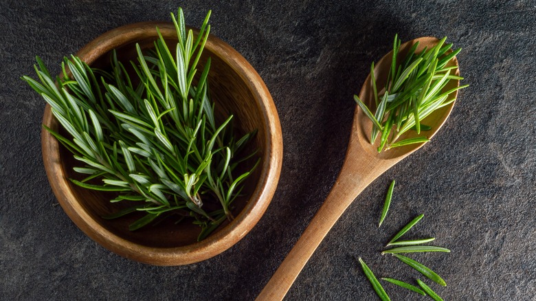 sprigs of rosemary in bowl and spoon