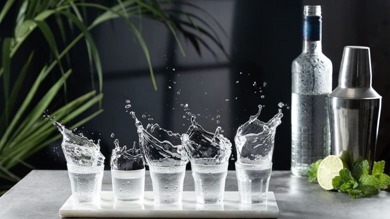 splashing shots of vodka with bottle