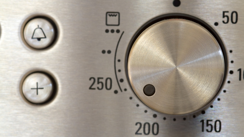 Person holding baking sheet with towel