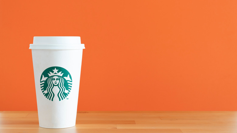 Starbucks cup with orange background 