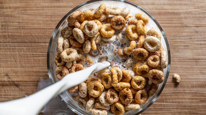 Milk pouring into a bowl of breakfast cereal