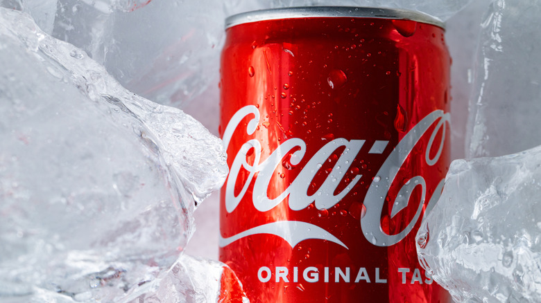A can of Coca-Cola surrounded by ice