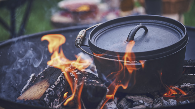 Black Dutch oven on campfire 