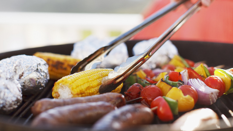 Assorted vegetables and sausage on grill