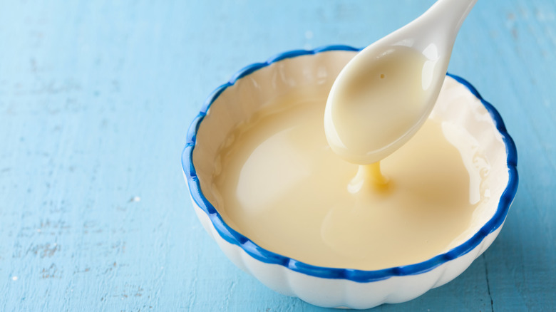 Spoon in a bowl of condensed milk