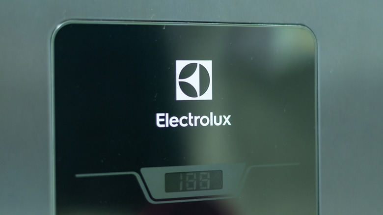 A close-up of an Electrolux logo on a black fridge