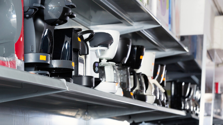 A selection of coffee machines on a store shelf