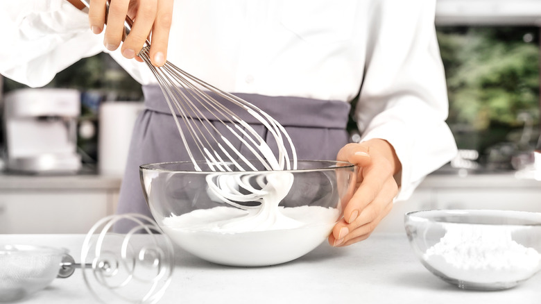 A person making whipped cream at home