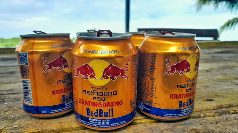 Krating Daeng cans on a wooden table