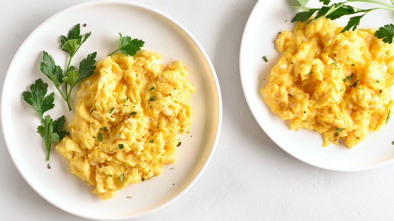 Two plates of scrambled eggs