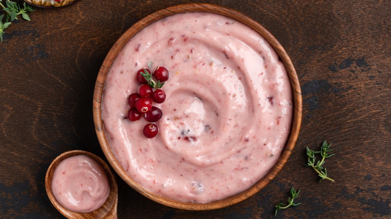 Cranberry mayo in a wooden bowl with spoon