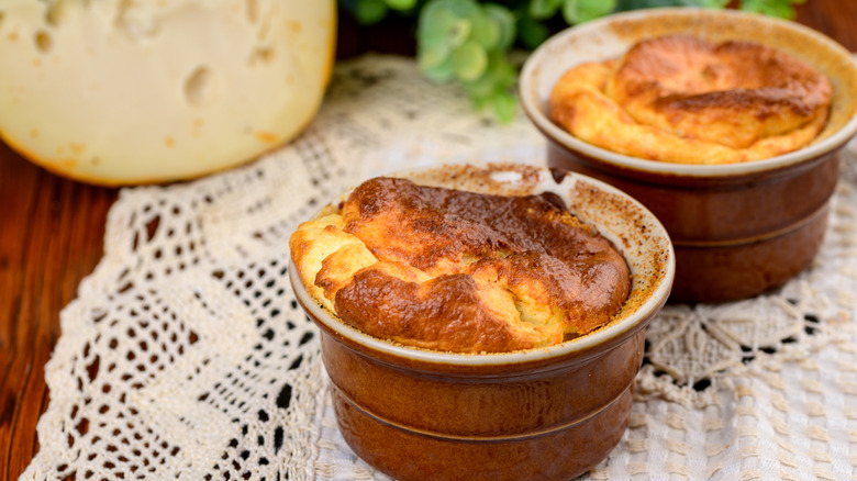 Baked soufflé in ramekins on a crocheted tablecloth