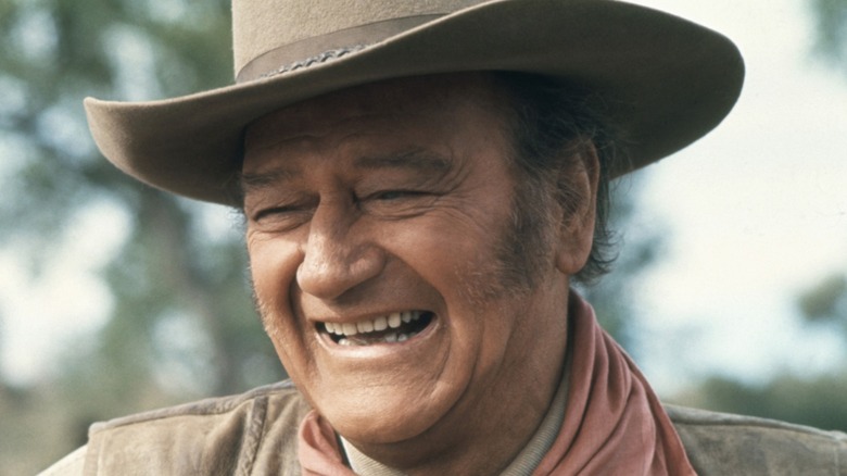 John Wayne laughing in a still from a movie