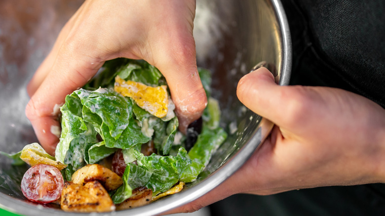 Hand tossing salad