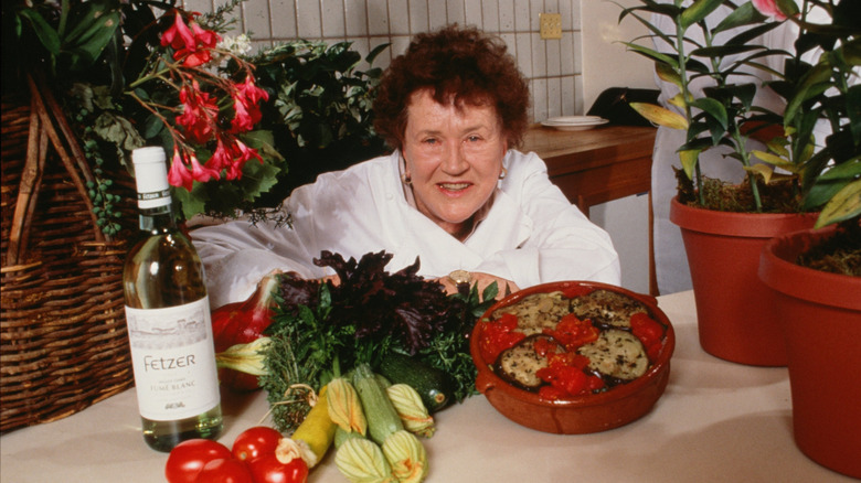 Julia Child in kitchen with herbs and vegetables