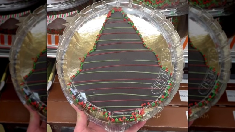 Hand holding Junior's Christmas Tree Cheesecake in package