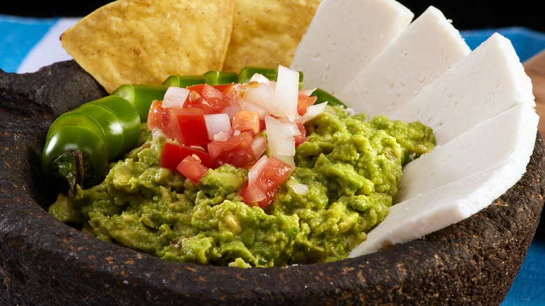 Guacamole with pico de gallo in bowl