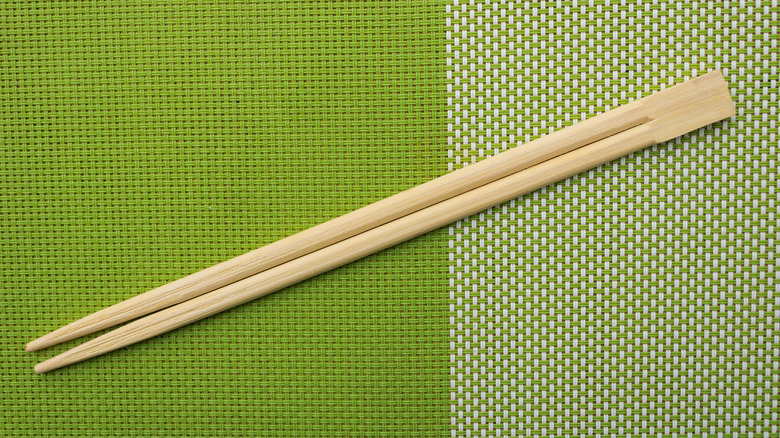 pair of chopsticks on green background