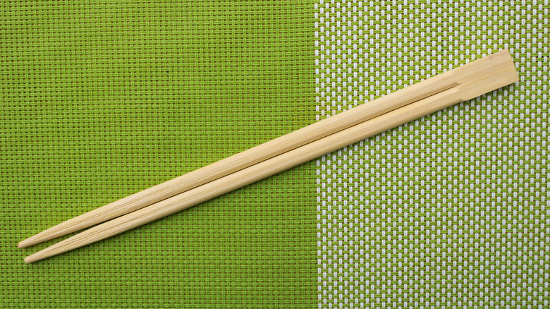 pair of chopsticks on green background