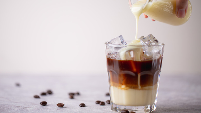 condensed milk poured into coffee