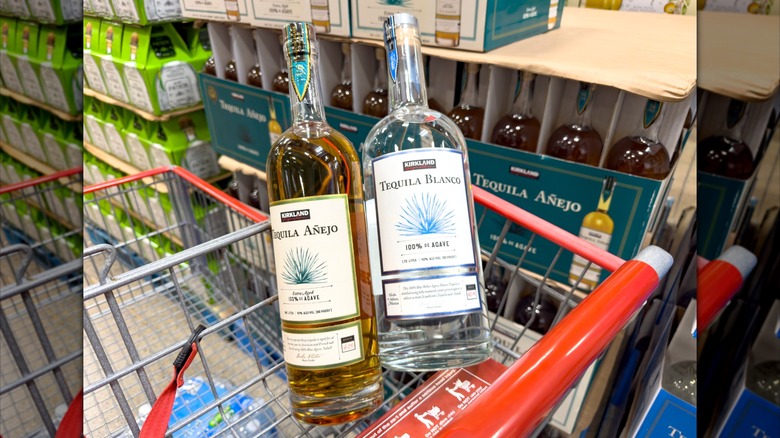 Kirkland Signature tequila blanco and añejo bottles in grocery cart